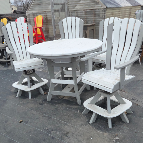 White wooden patio furniture set with four chairs and a round table on a wooden deck. The chairs are Adirondack style, creating a cozy, rustic vibe.