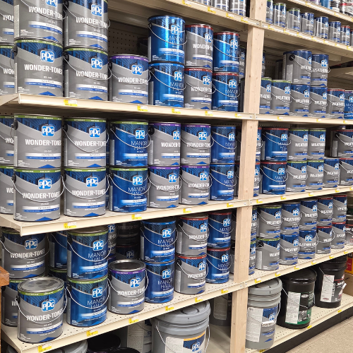 Shelves filled with rows of blue PPG paint cans labeled 