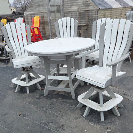 Outdoor Poly FurnitureWhite wooden outdoor furniture set with four Adirondack-style chairs around a round table, placed on a dark deck. Bright red and yellow chairs are behind.